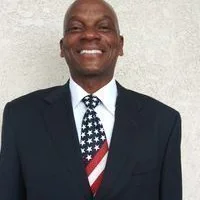 Official portrait of Kamau Bakari